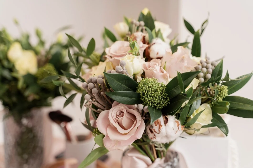 Soft pink and ivory floral arrangement in a premium lobby setting