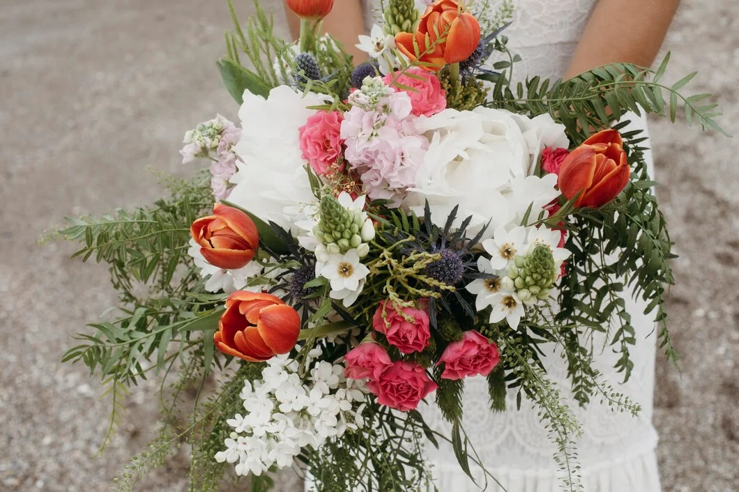 White and coral floral bouquet arranged on a tabletop