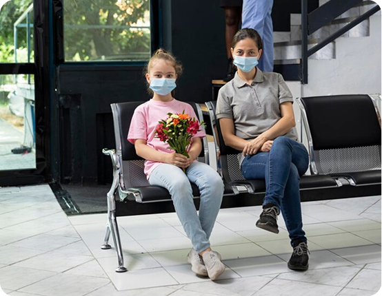 Visitors seated with flowers in a hospital lobby